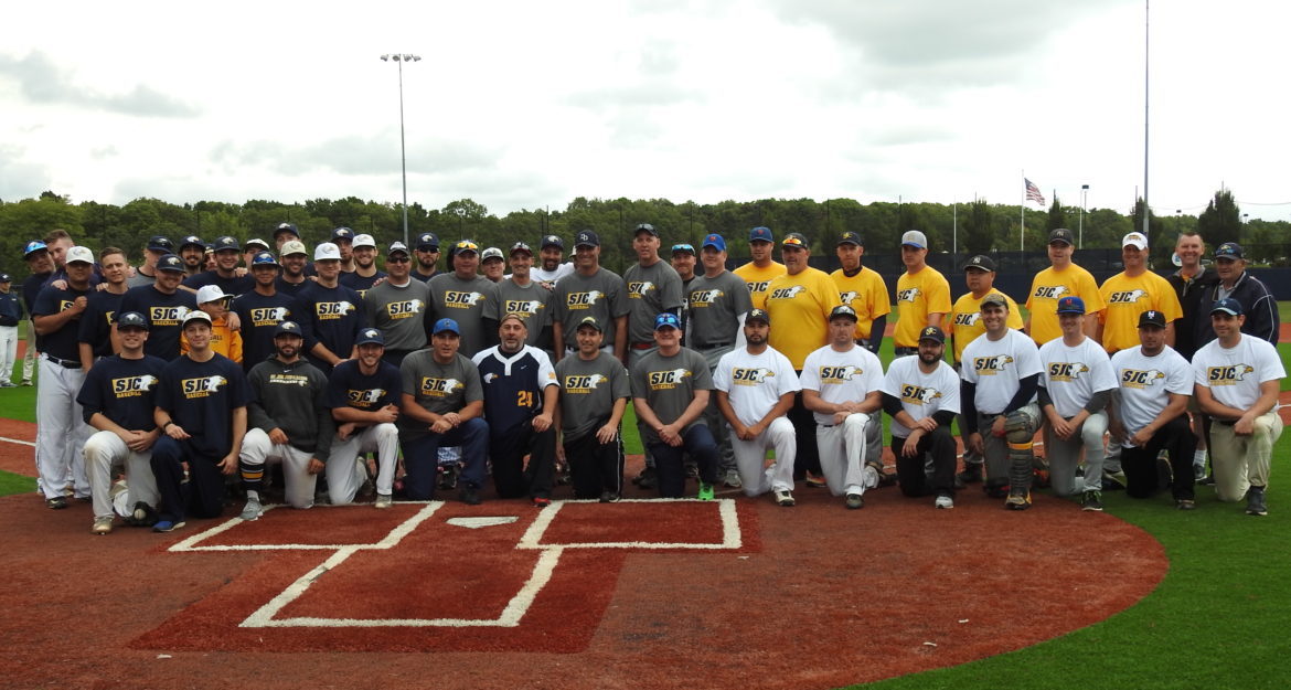 SJC baseball alumni posing on the field.