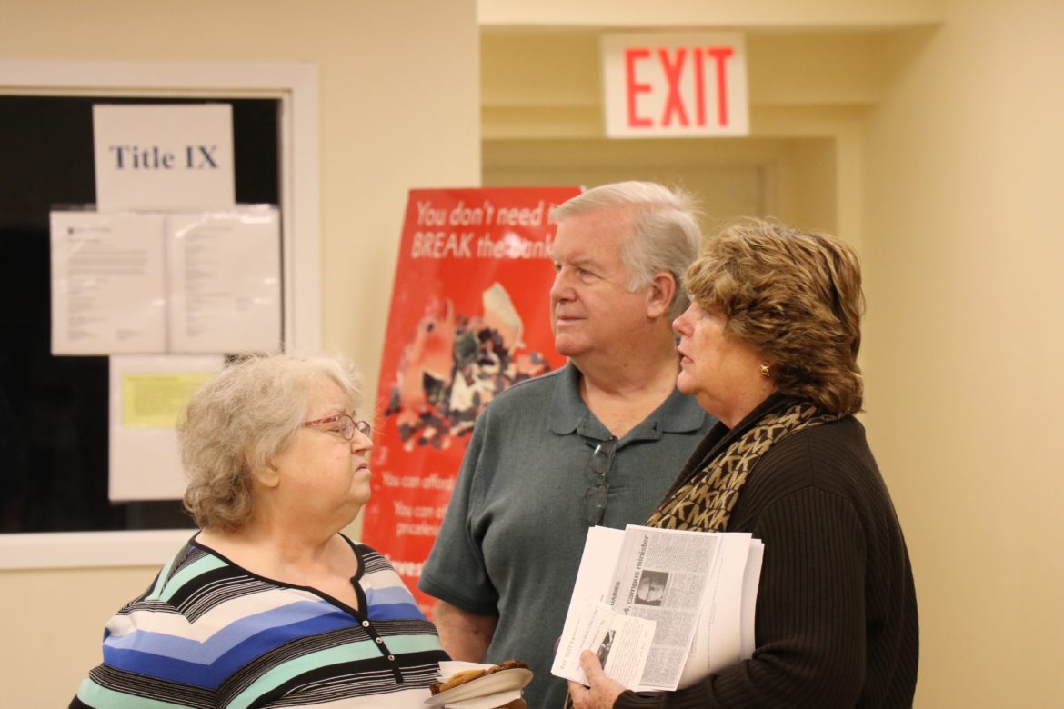 Three people chatting.