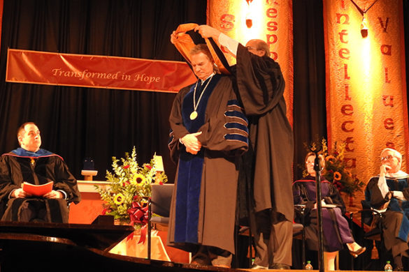 President is hooded at ceremony.