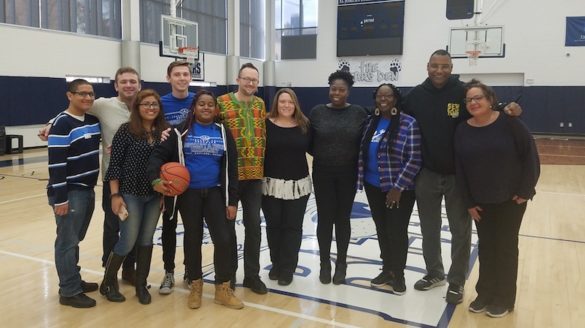 People standing in a gymnasium.