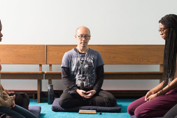 Dr. Lin meditating with students.