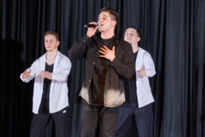 Three singers on stage.