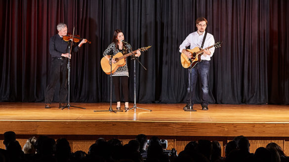 Three people on a stage.