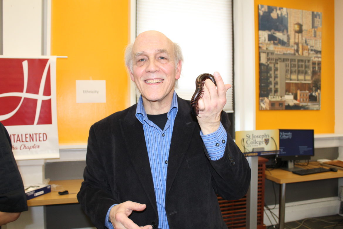 Louis Sorkin holding a millipede.