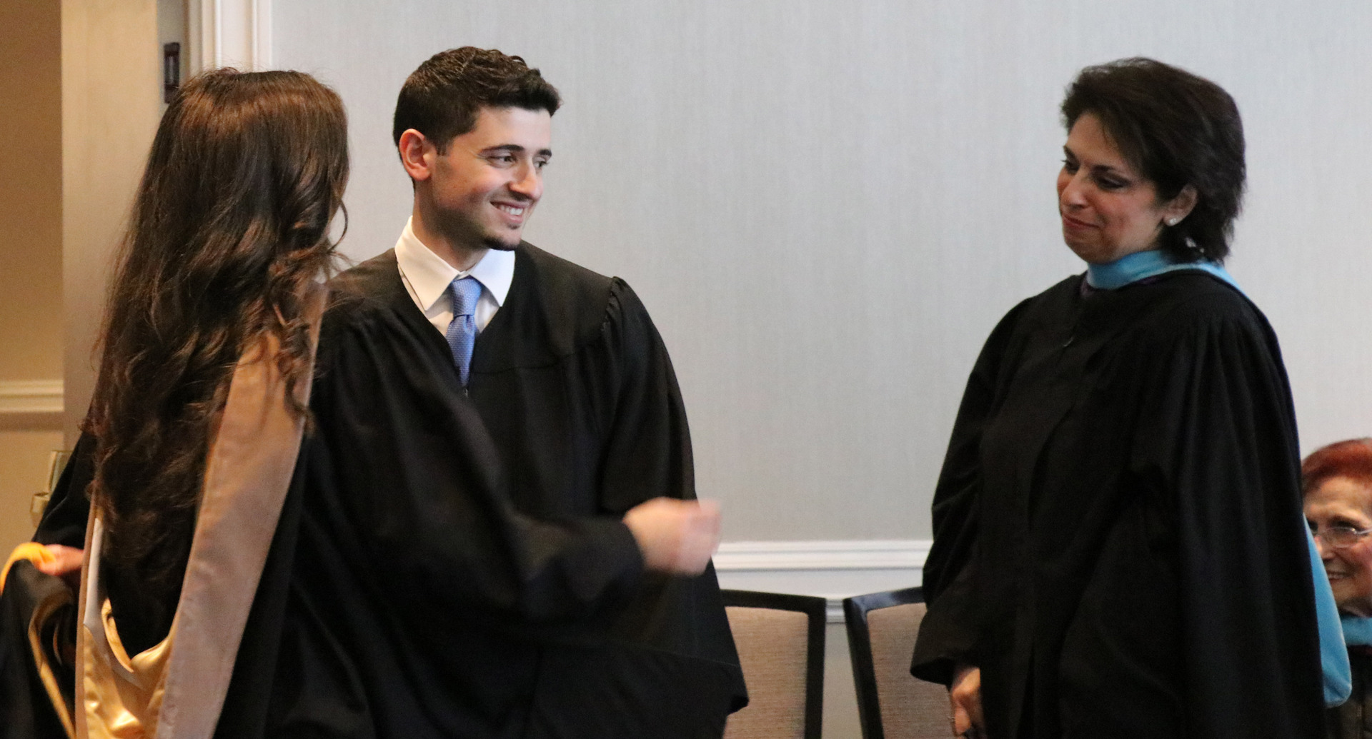 Jonathon Gallo with his mother and sister at SJC Brooklyn's 2018 graduation.