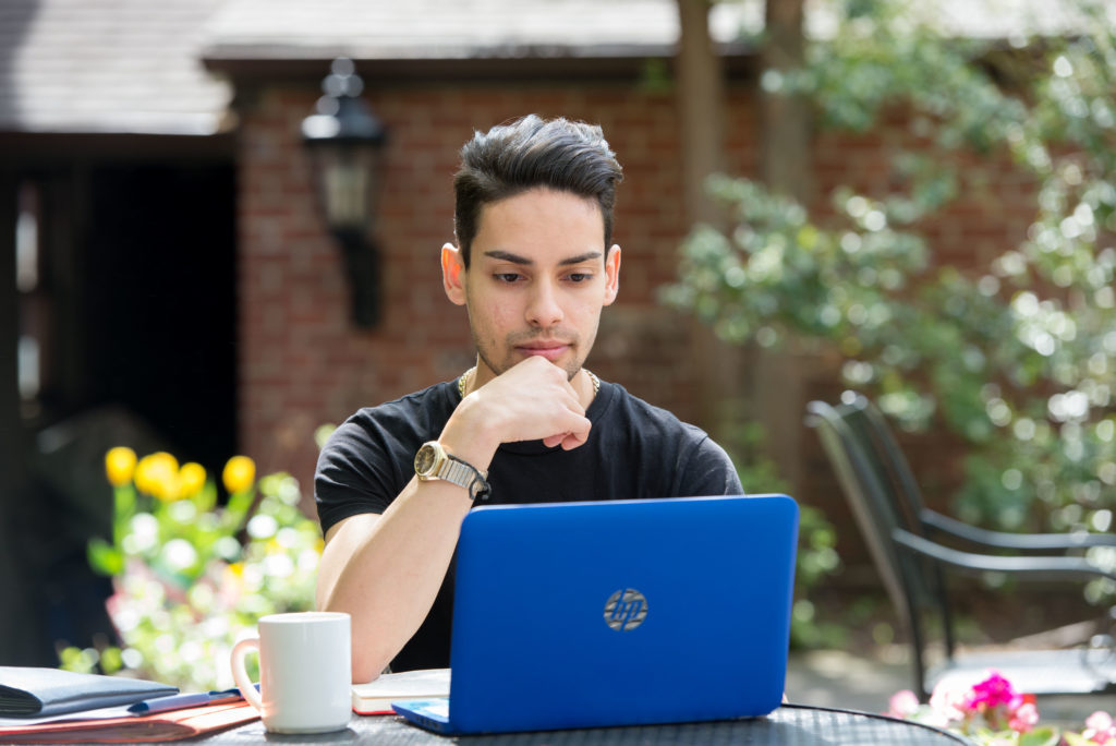 SJC student working on his laptop.