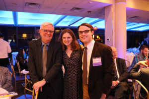 Three people standing together.