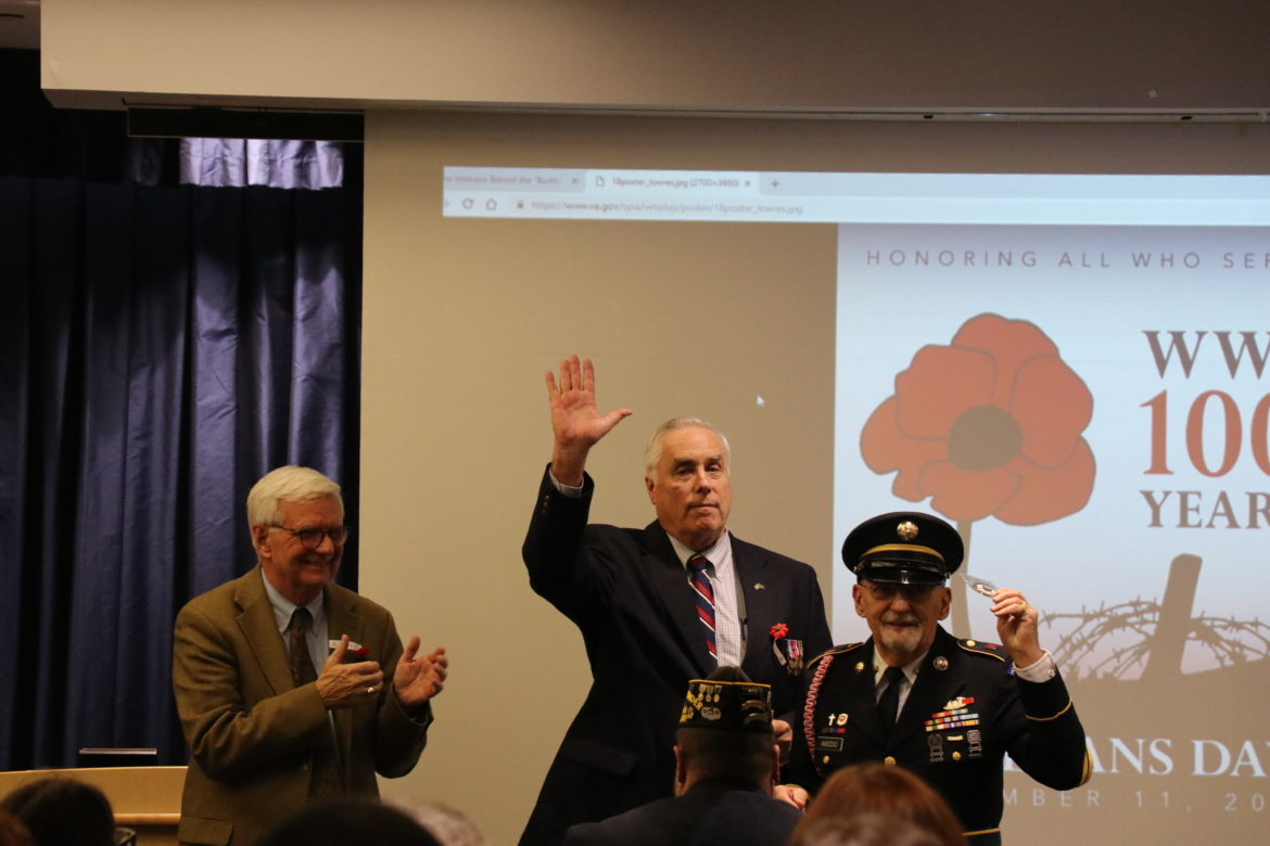 Local veteran receiving Challenge Coin from Dr. Travis and Dr. Vitters.