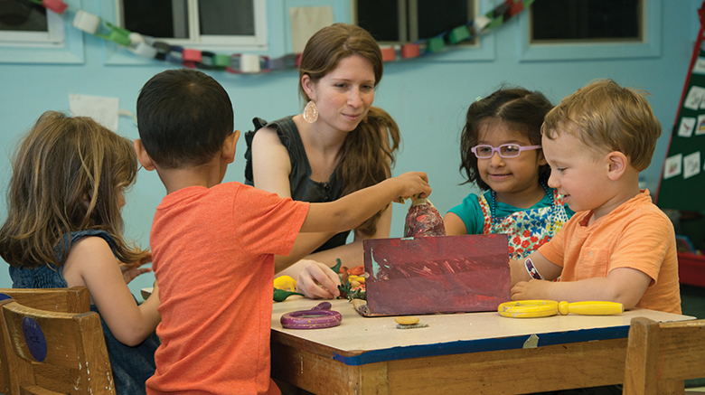 Children playing with a child study major in the Dillon Center. 