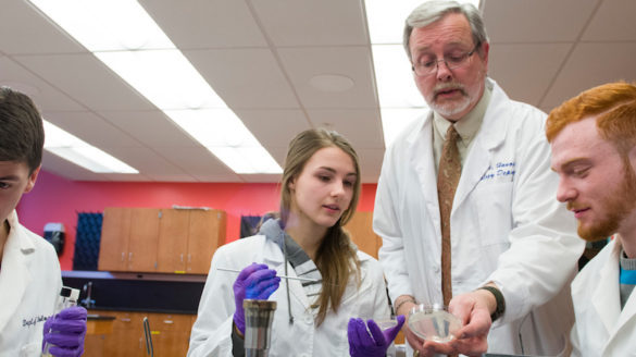 Teacher and students in science lab.