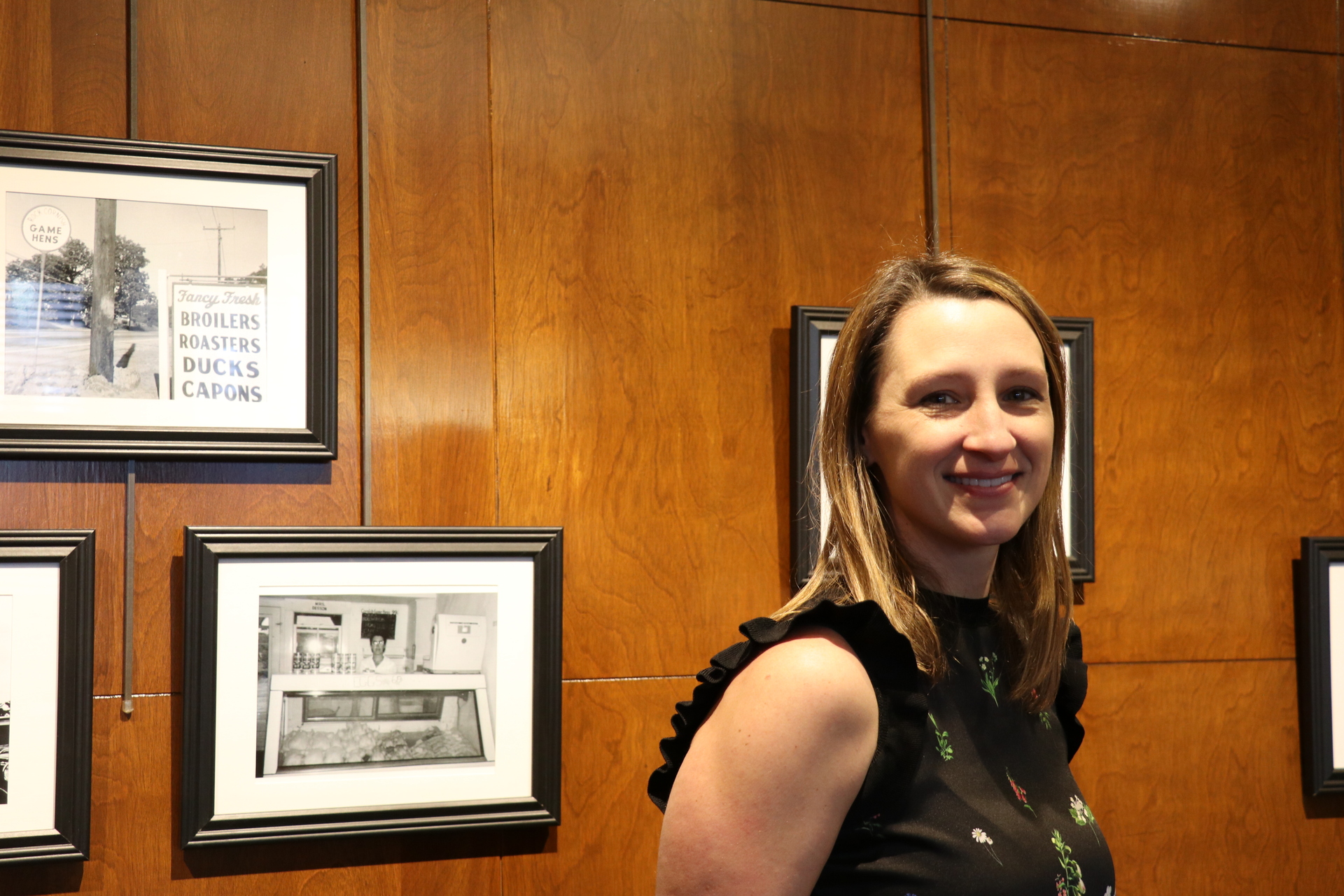 Dr. Van Scoy in front of her art exhibit.