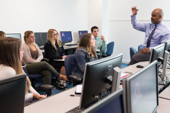 Professor in classroom with students.