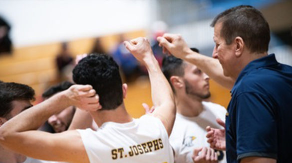 Coach Kropp with SJC Long Island men's volleyball players