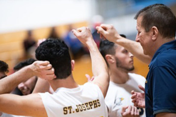 Coach Kropp with SJC Long Island men's volleyball players