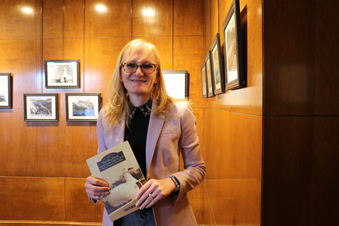 Dr. Heather Barry holding her copy of Dr. Van Scoy's book.