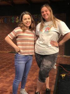 Two female students standing.