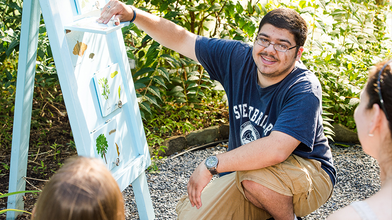 Christopher Lo Re teaching about different butterflies in the Butterfly Vivarium at Sweetbriar Nature Center.