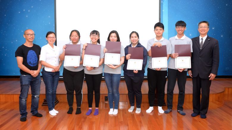 A group of students standing on stage.