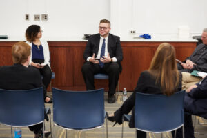 Student seated at roundtable discussion.