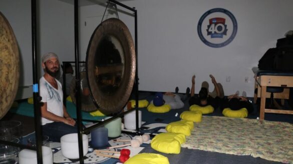 Man seated in sound room.