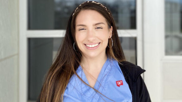 College student dressed for work and smiling.