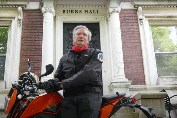 Dr. Boomgaarden on the back of his motorcycle while congratulating the Class of 2020.