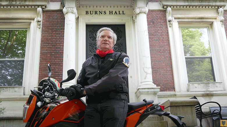 Dr. Boomgaarden on the back of his motorcycle while congratulating the Class of 2020.