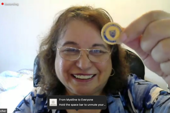 Woman holding up a pin.