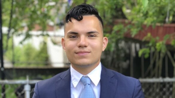 Student in jacket and tie.