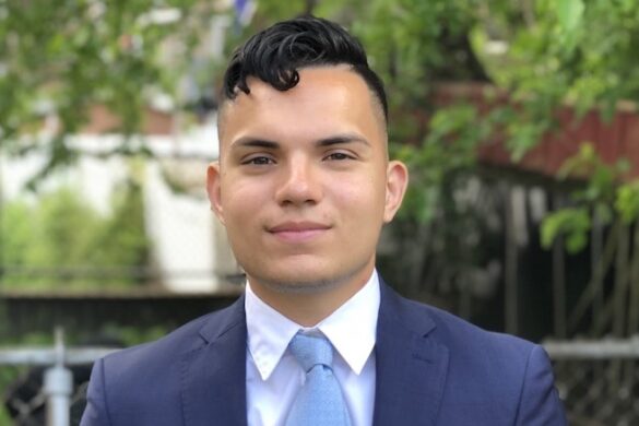 Student in jacket and tie.