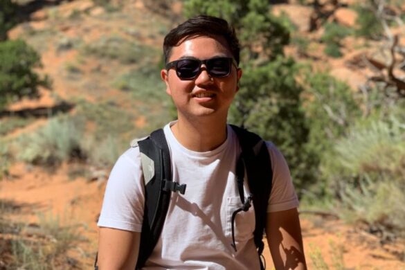 Student in desert with sunglasses.
