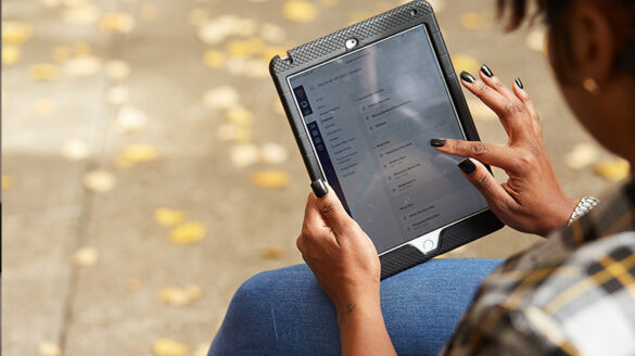 student taking an online course on a tablet, were no textbooks are required.