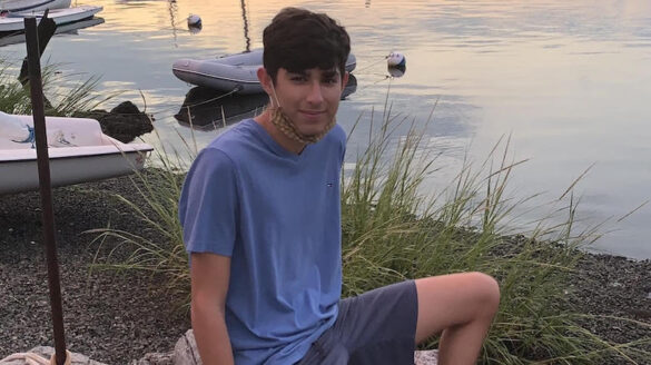 Student sitting by the water.