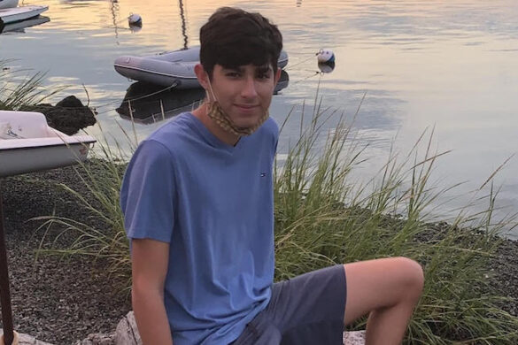 Student sitting by the water.