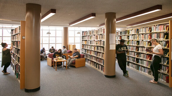 Walls of books in SJC Long Island's Callahan Library.