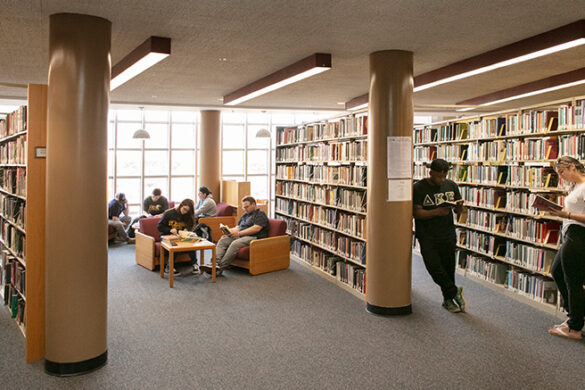 Walls of books in SJC Long Island's Callahan Library.