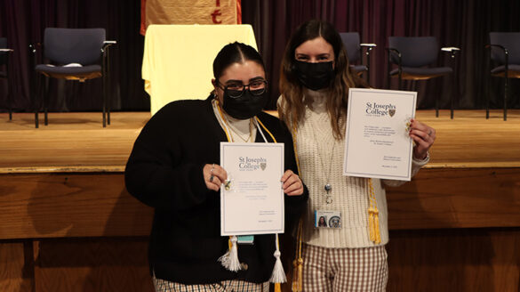 Honors Convocation at SJC Long Island, where two students pose with their pins and cords.