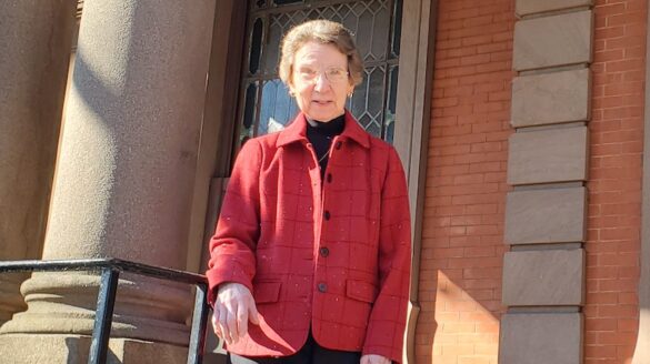 Sister Elizabeth on the steps outside hall.