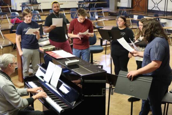 Students singing with professor