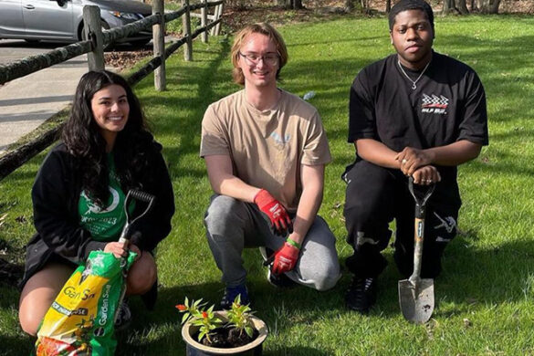 Students planting flowers at the Clare Rose Playhouse for Earth Week.