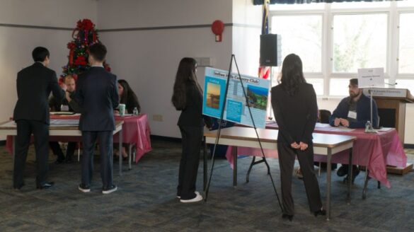 Students standing in a room.