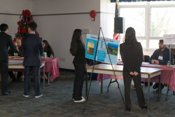 Students standing in a room.